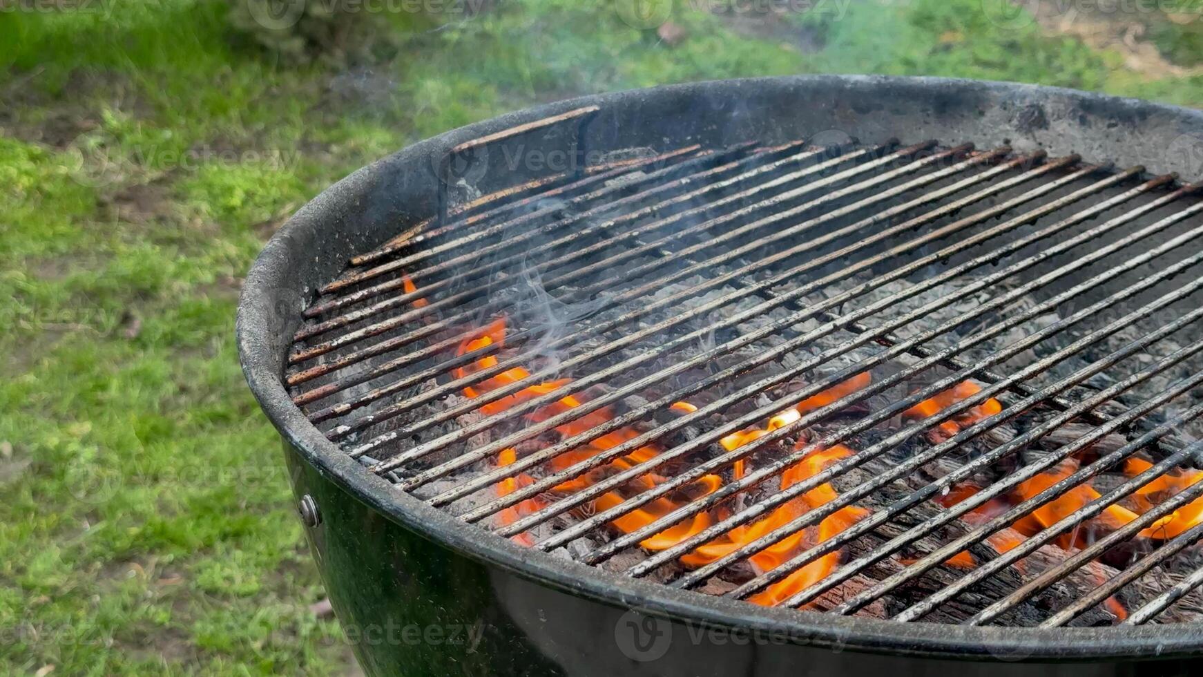 Outdoor grill with glowing embers, backyard barbecue setup, summer cookout preparation, National Barbecue Week celebration, food festivity scene photo