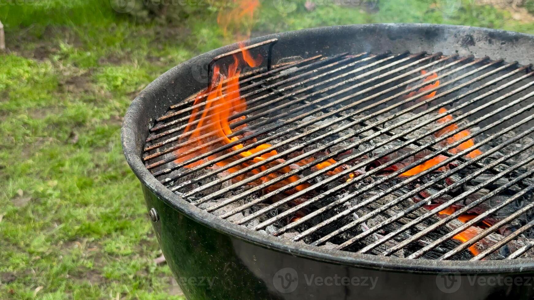 Flames rising from a charcoal grill, perfect for summer barbecues, outdoor cookouts, and picnic gatherings photo