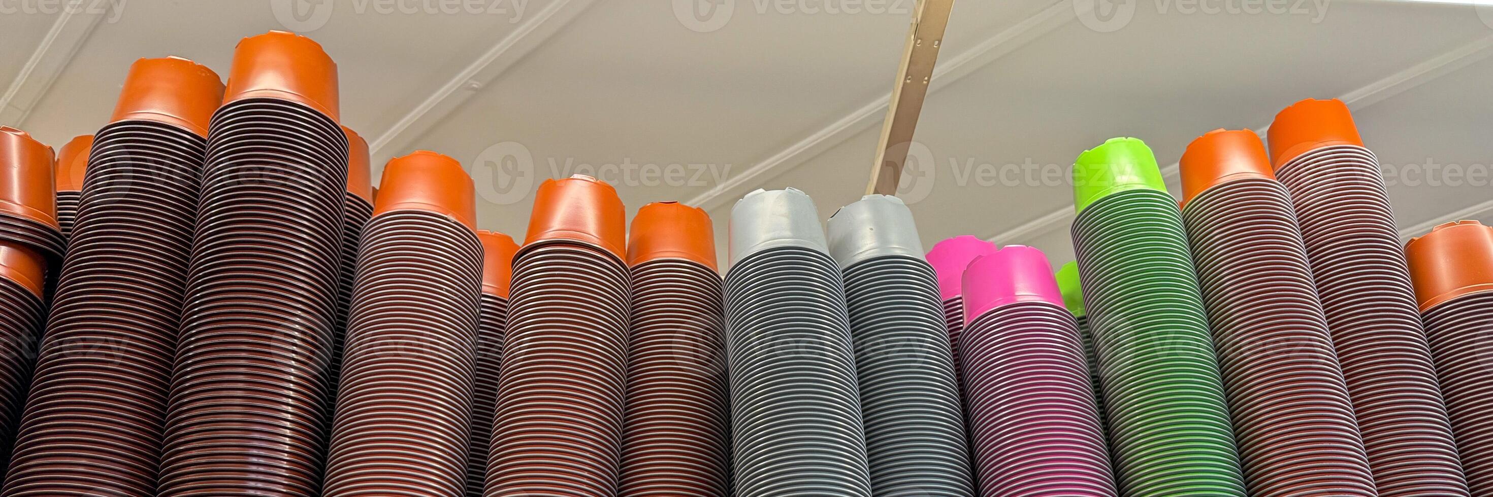 Giant whimsical stacks of multicolored cups, vibrant confetti towers, evoking urban carnival vibes, perfect for International Coffee Day celebrations photo
