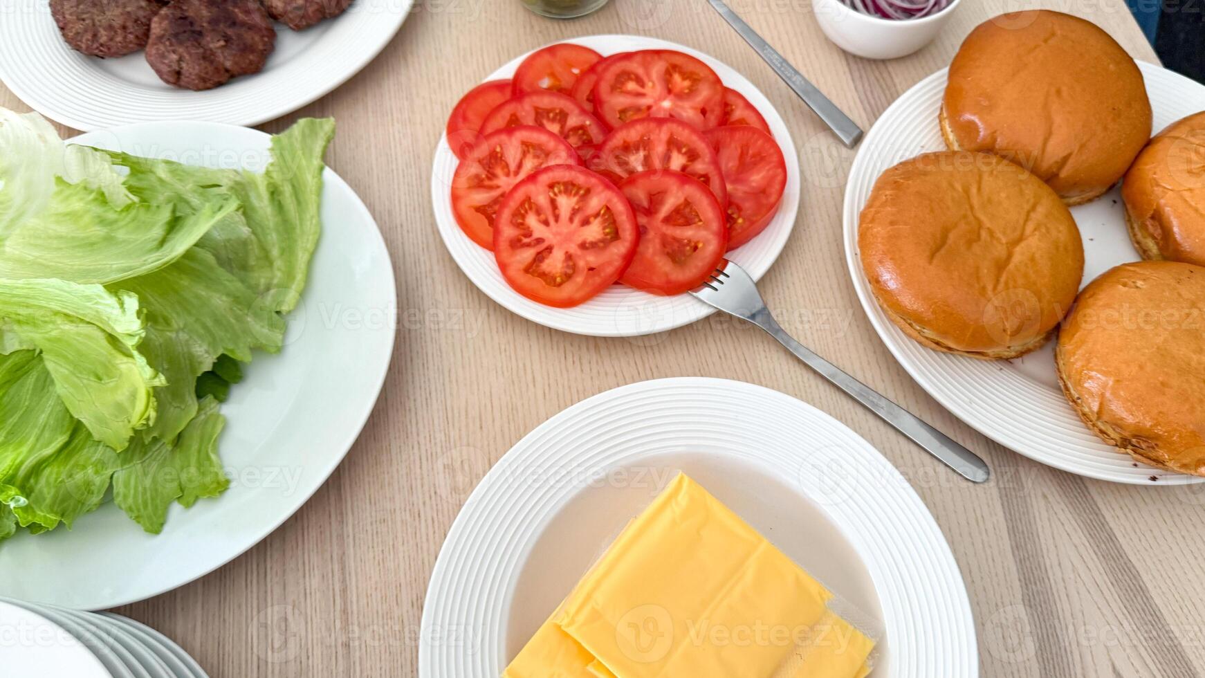 Fresh burger ingredients on a wooden table, summer barbecue preparation, American picnic, Independence Day celebration photo