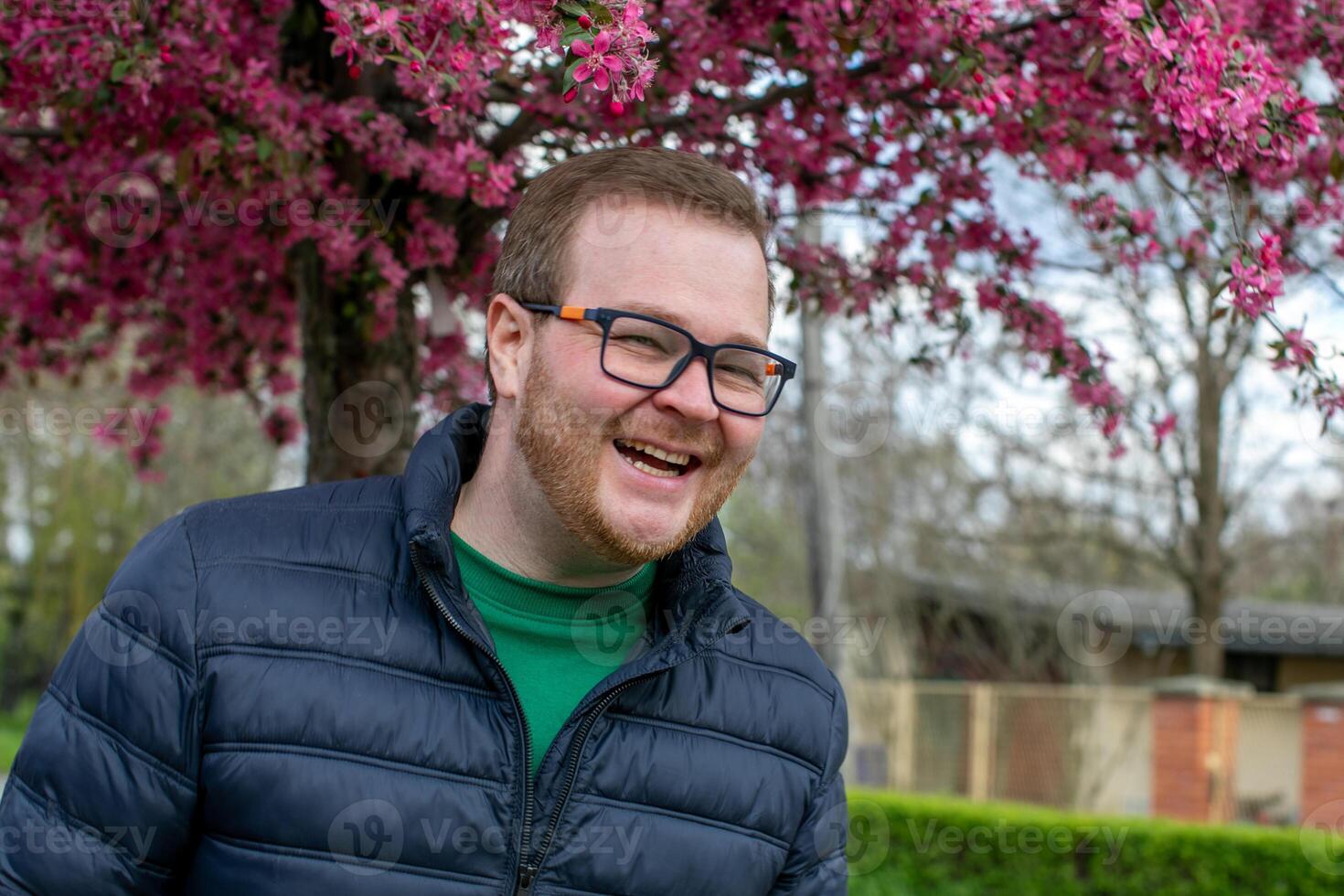 Cheerful European man basking under cherry blossoms, capturing Ostara vibes, spring rejuvenation, and whimsical pollen symphony photo