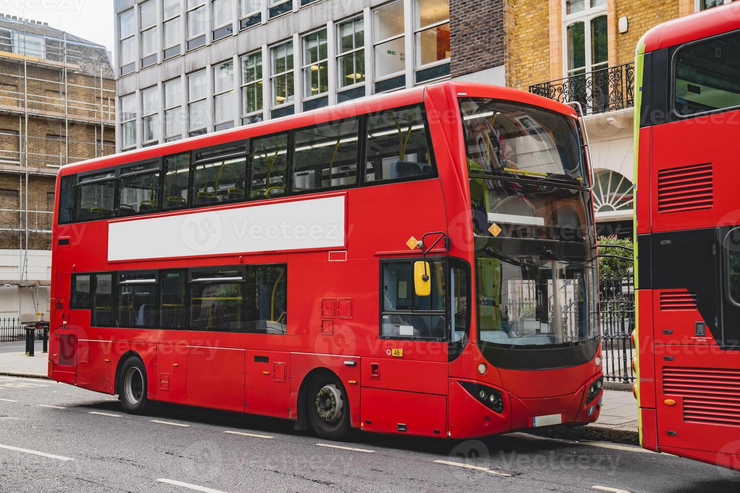 The blank ad space on the red bus contrasts with the classic charm of the calm London street. d photo