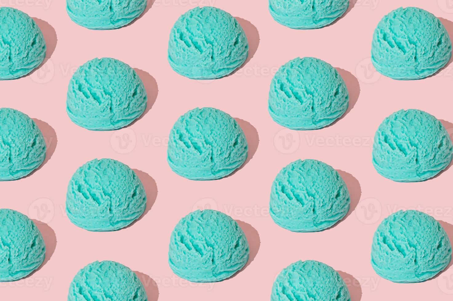 Blue ice cream pattern on pastel pink background. Summer food concept. Minimal isometric layout. Ice cream scoop aesthetic background idea. photo