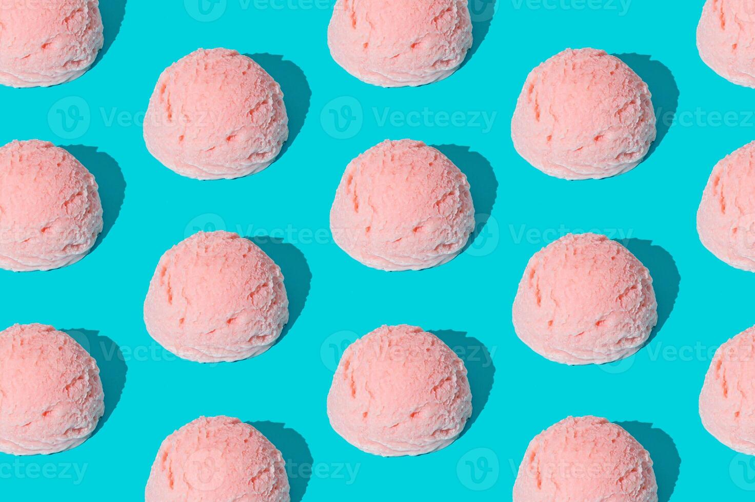 Pink strawberry ice cream pattern on light blue background. Summer food concept. Minimal isometric layout. Ice cream scoop aesthetic idea. photo