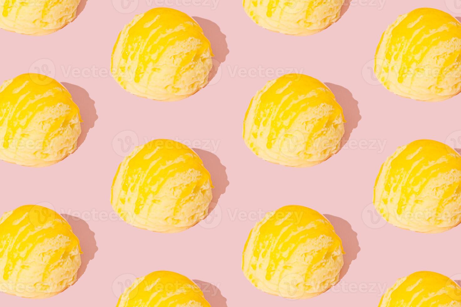 Yellow banana ice cream pattern on pastel pink background. Summer food concept. Minimal isometric layout. Ice cream scoop aesthetic background idea. photo