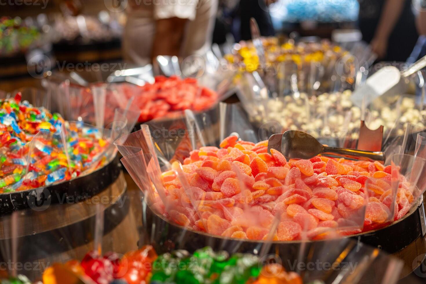 Colorful candy display with various sweets at a local market during the afternoon photo