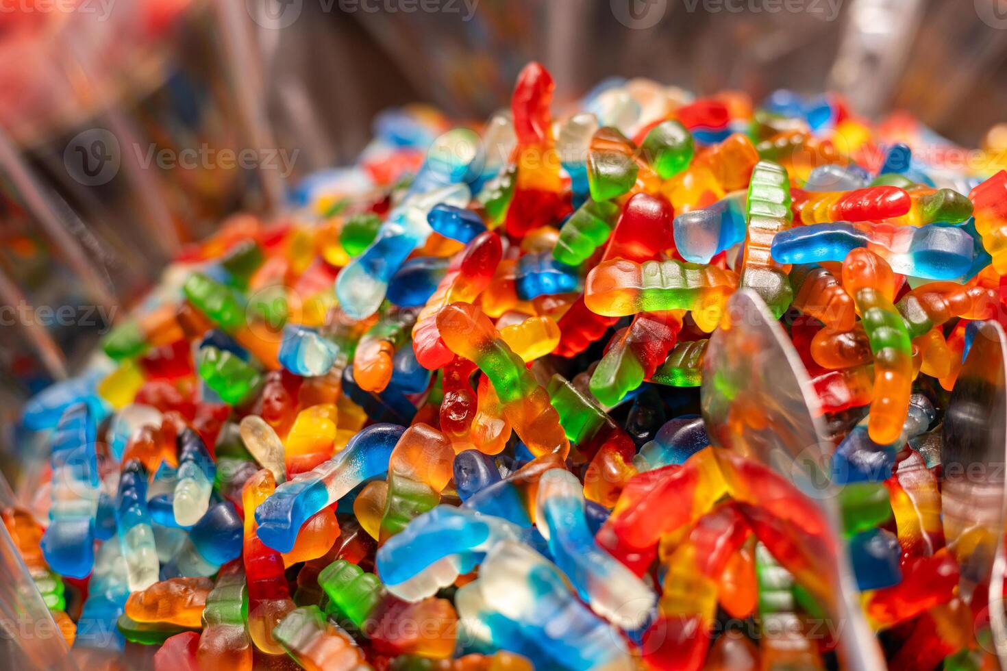 Colorful gummy candy displayed in a bowl at a festive event during the afternoon with a mix of assorted flavors and shapes photo