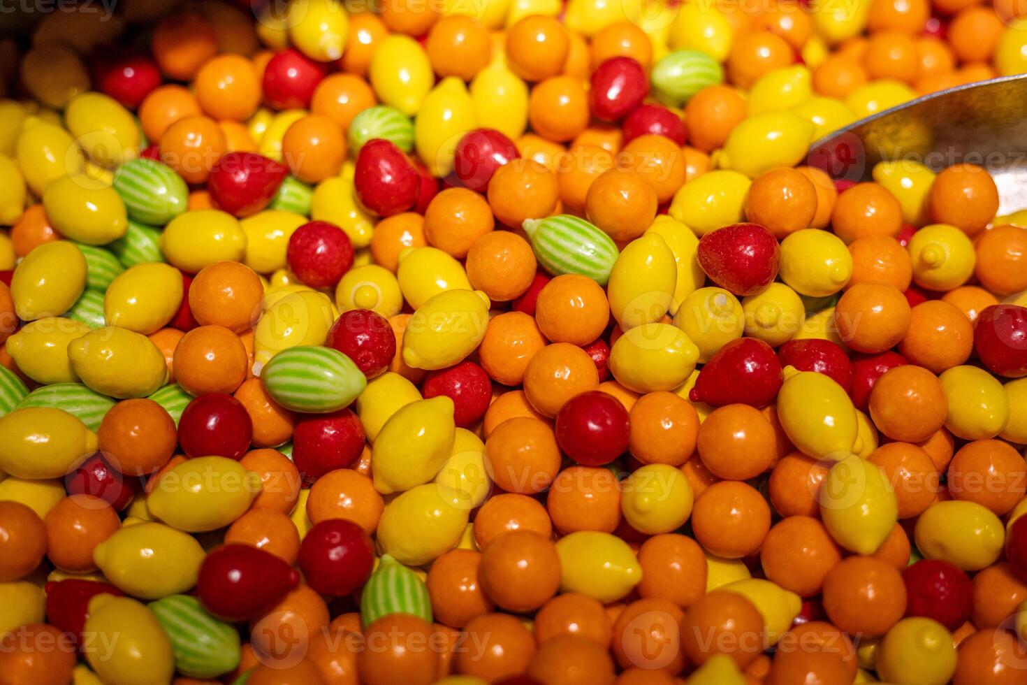 Colorful assortment of candy resembling fruits in a vibrant display at a local confectionery shop photo