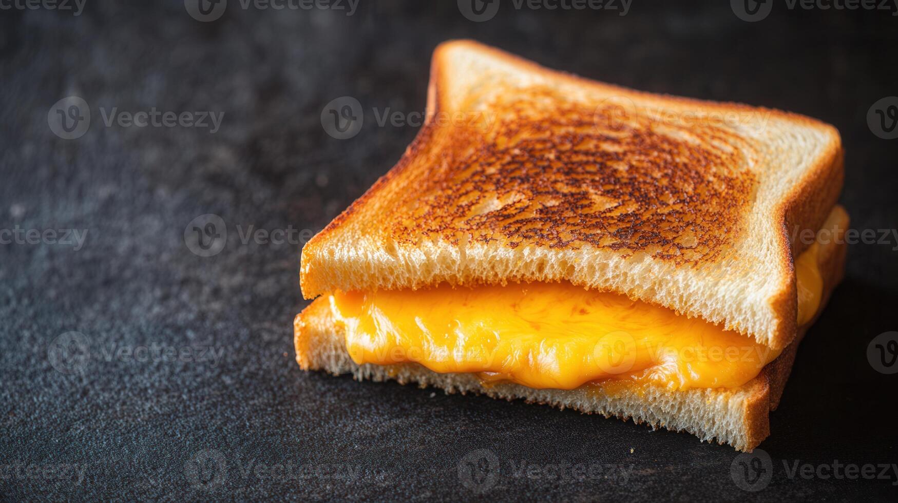 Perfectly grilled cheese sandwich with golden brown bread and melted cheese oozing out from between the slices photo