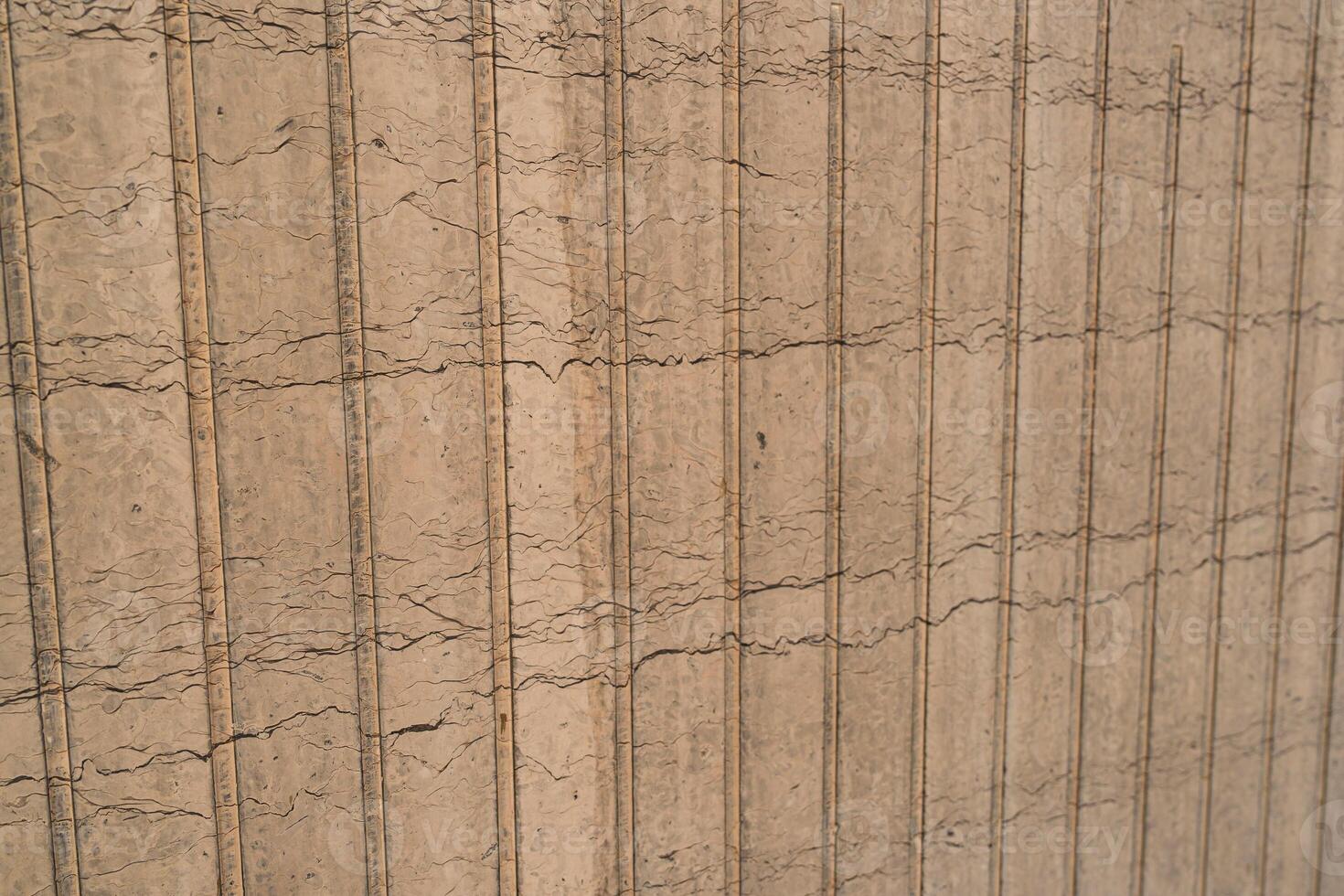 Patterns of cracked earth highlight drought conditions in an agricultural field during late summer photo