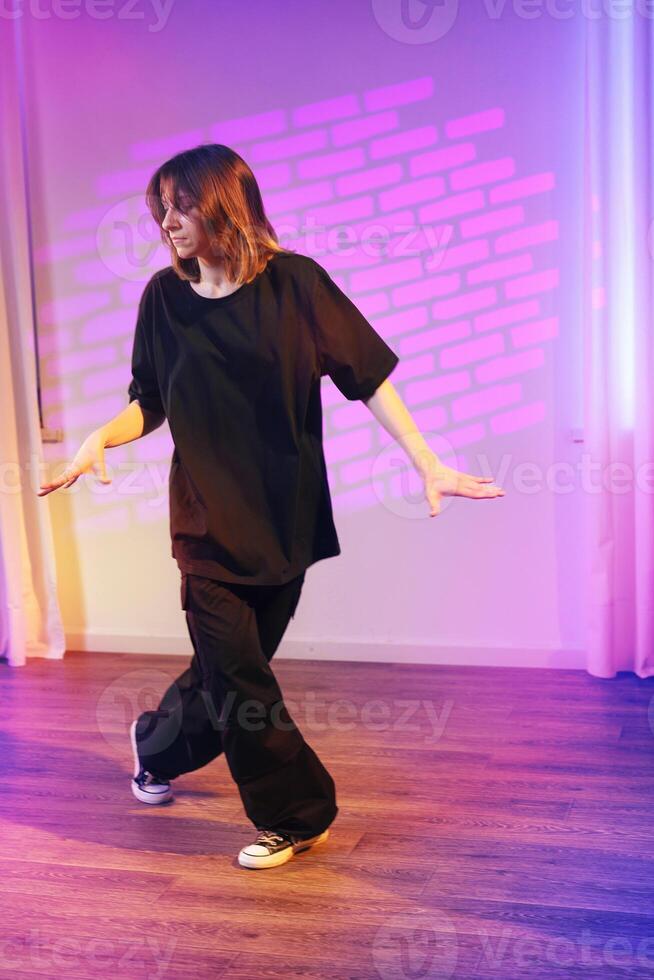 Dancer performs contemporary choreography in a vibrant studio setting with creative lighting effects photo