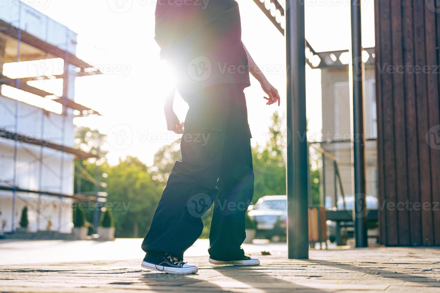 Casual walk at sunset in an urban environment with a construction backdrop photo