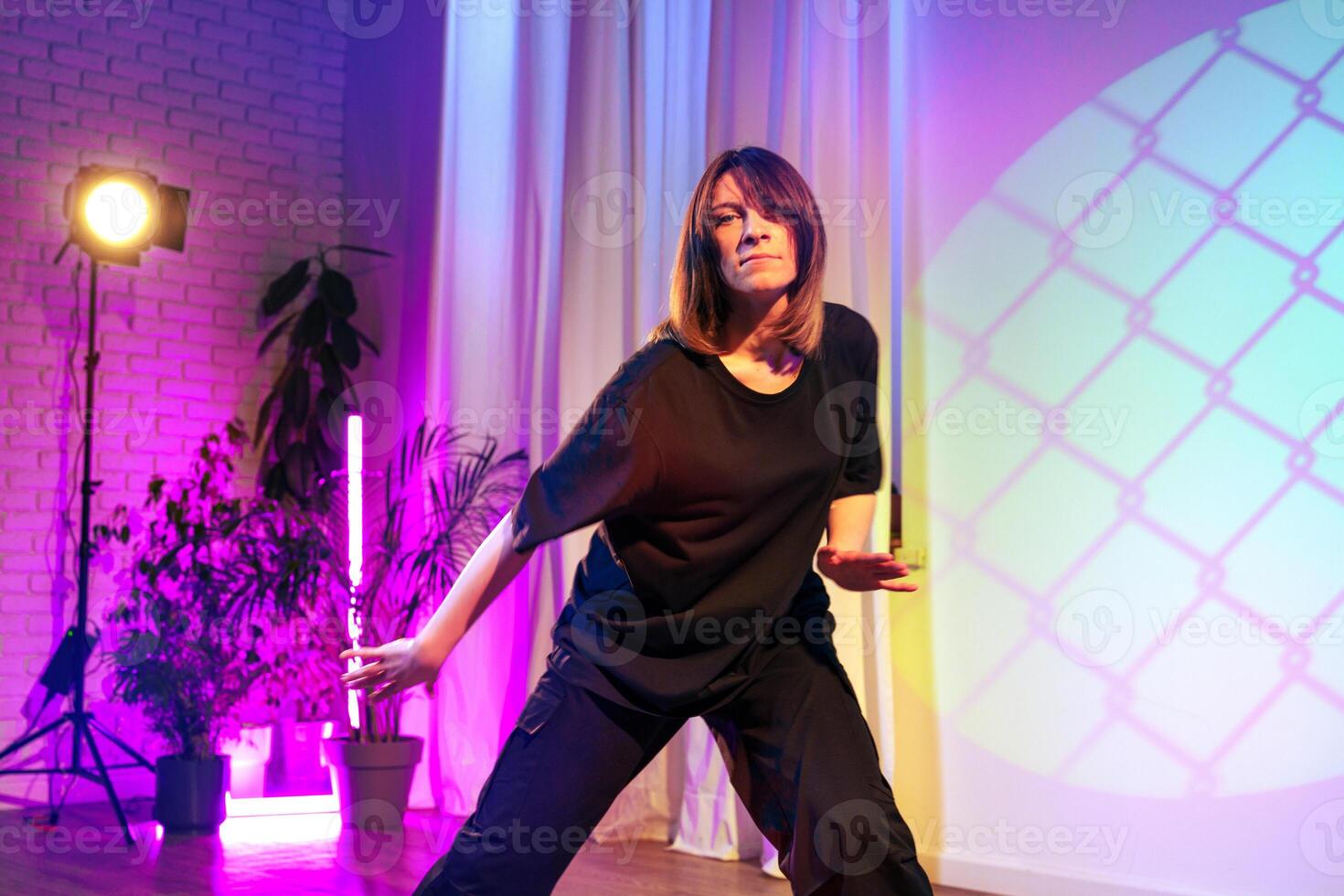 Energetic dance performance captured in vibrant lighting during an artistic showcase at a local studio photo