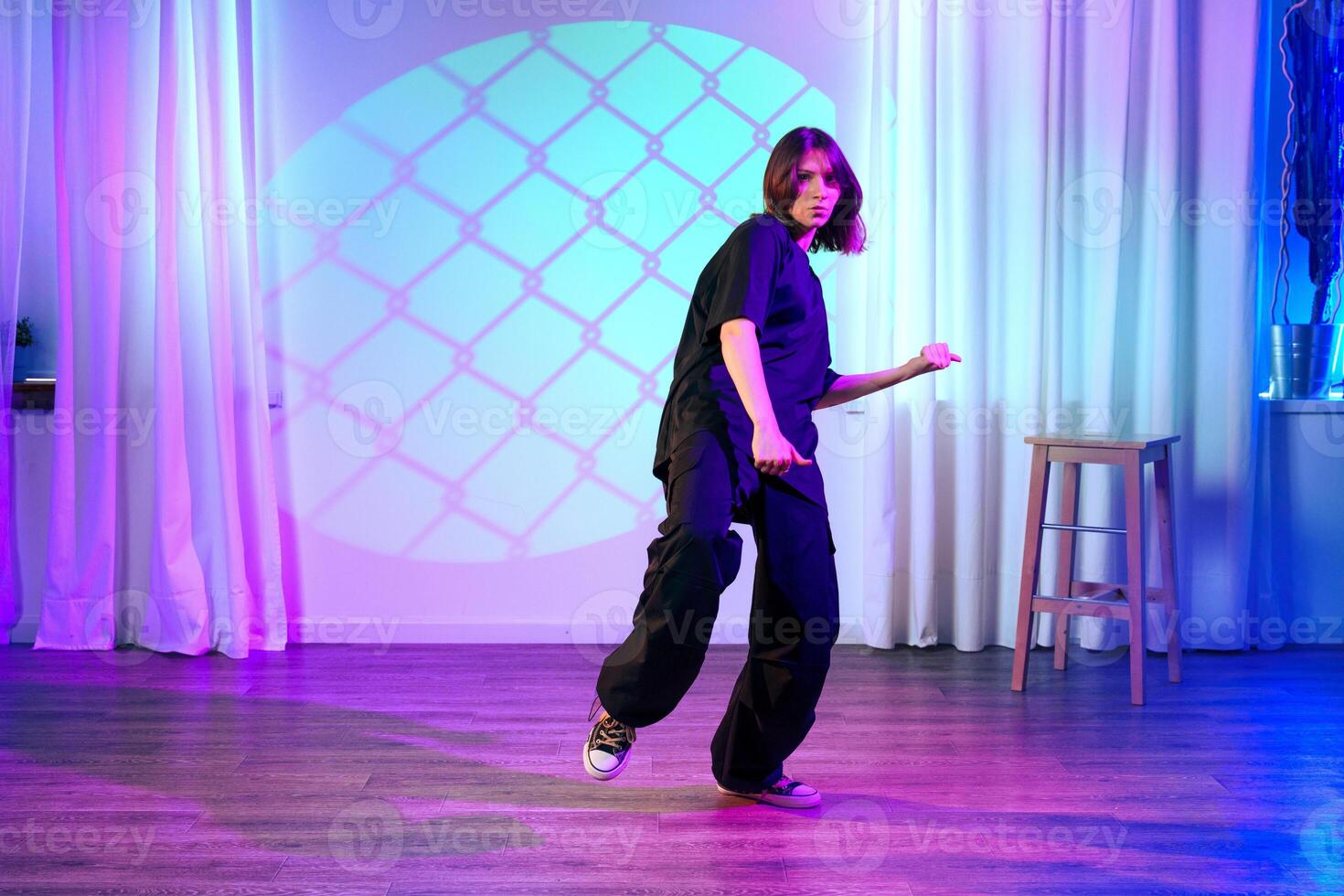 Dance performance in a colorful studio with unique lighting, showcasing expressive movements and creative style photo