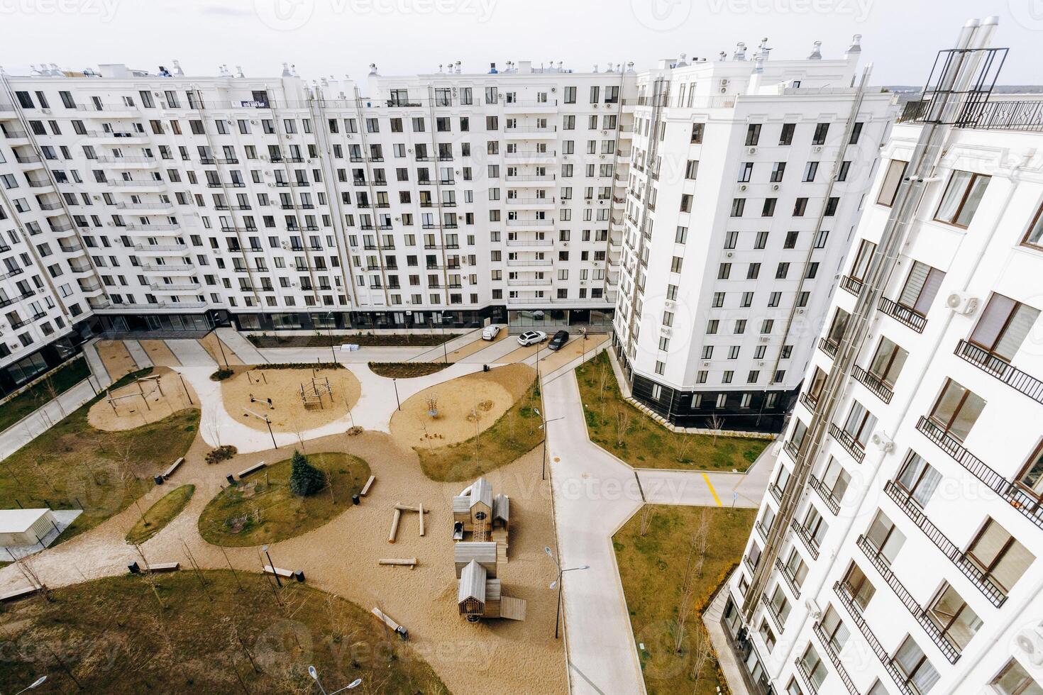 Aerial view of a large apartment building with a playground photo