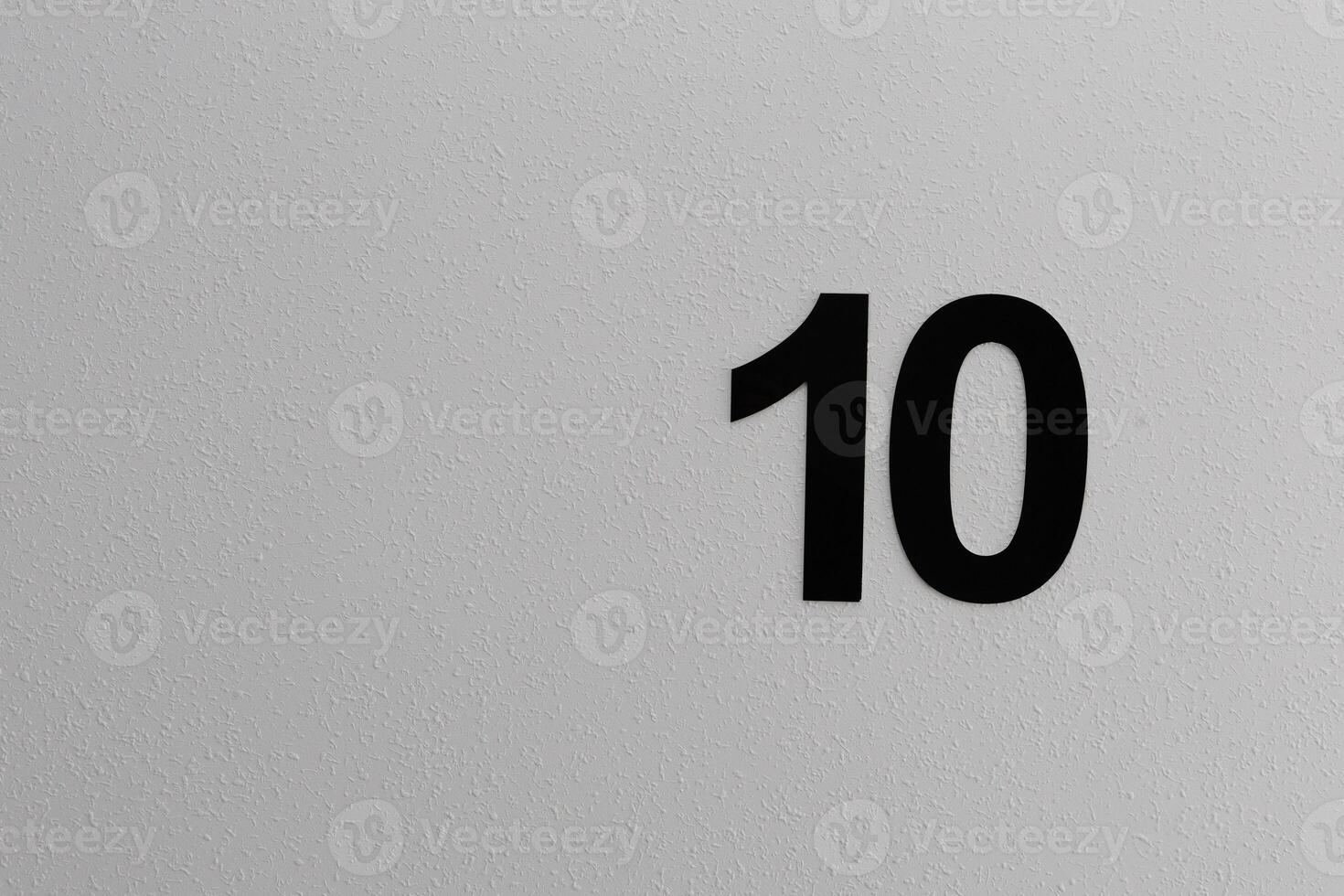 The number 10 is clearly written in black on a white surface photo