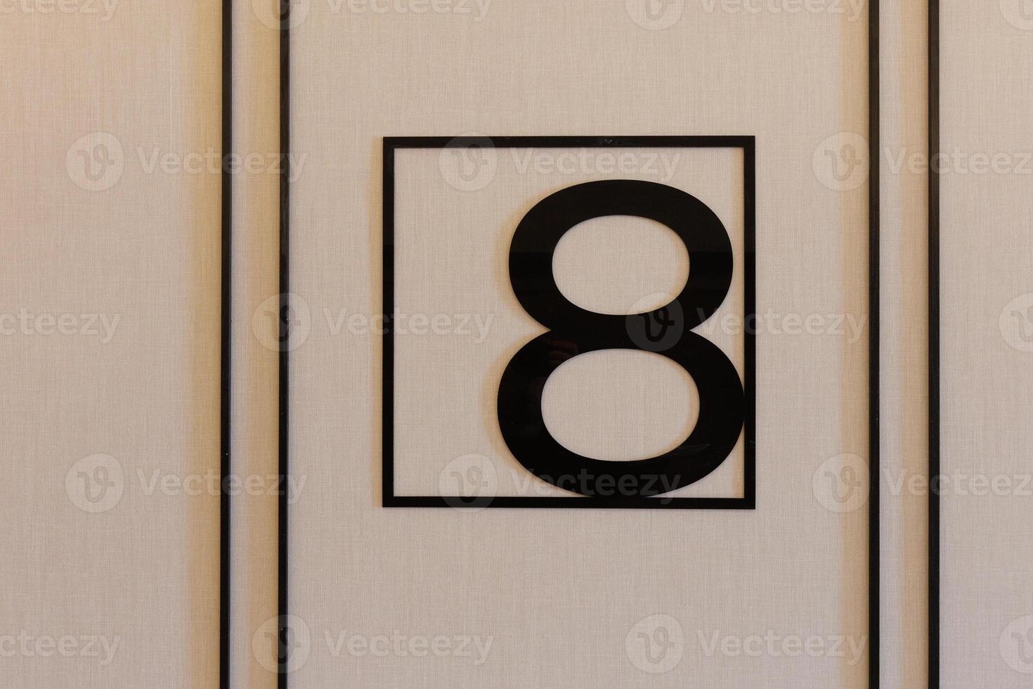 A black and white sign featuring the number eight prominently displayed on it photo