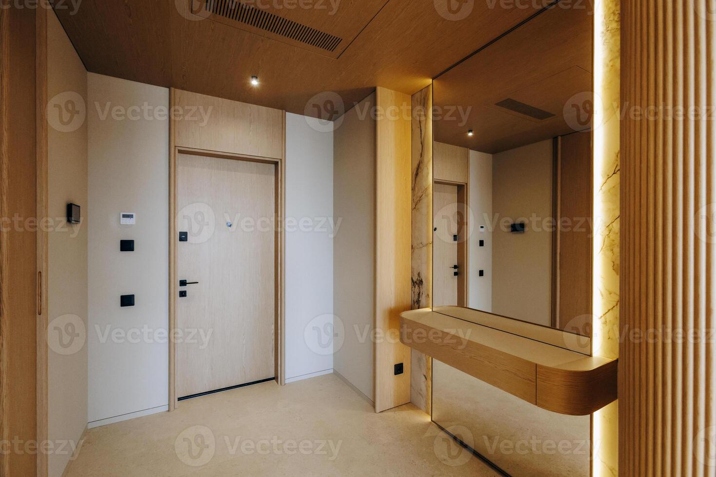 A hallway featuring a mirror mounted on the wall along with a door photo