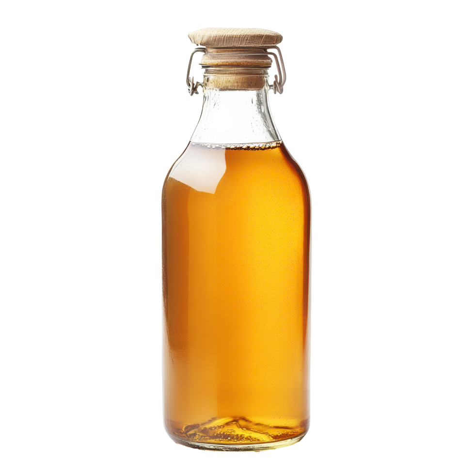 Glass bottle filled with golden liquid sits on a rustic table in a cozy kitchen environment during afternoon light png