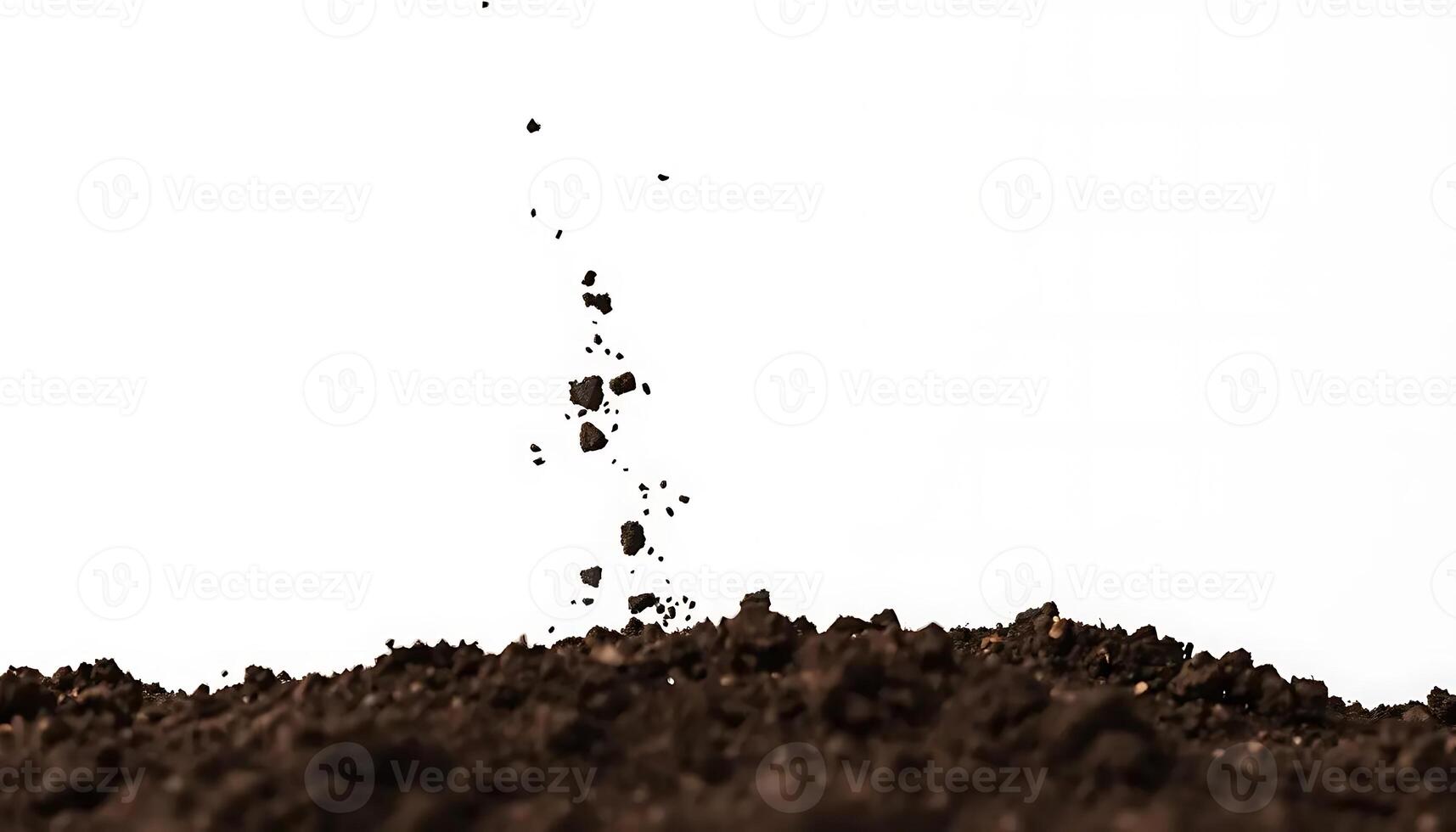Soil Particles Falling onto Dark Earth Against White Background photo