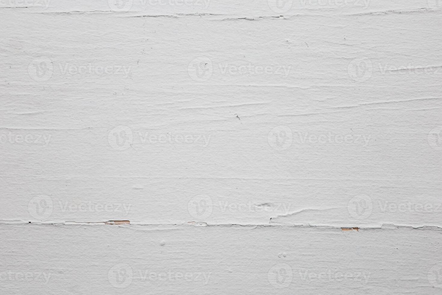 Textured white wooden surface with natural patterns and subtle imperfections in warm lighting photo