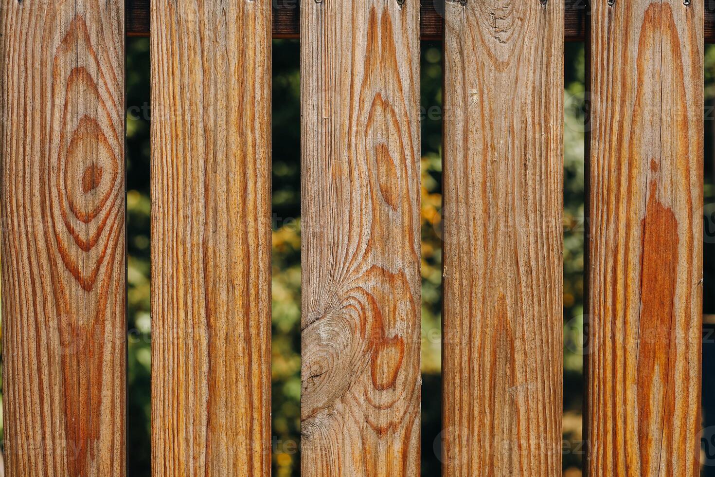 Natural wooden fence planks creating an organic look in a garden setting photo