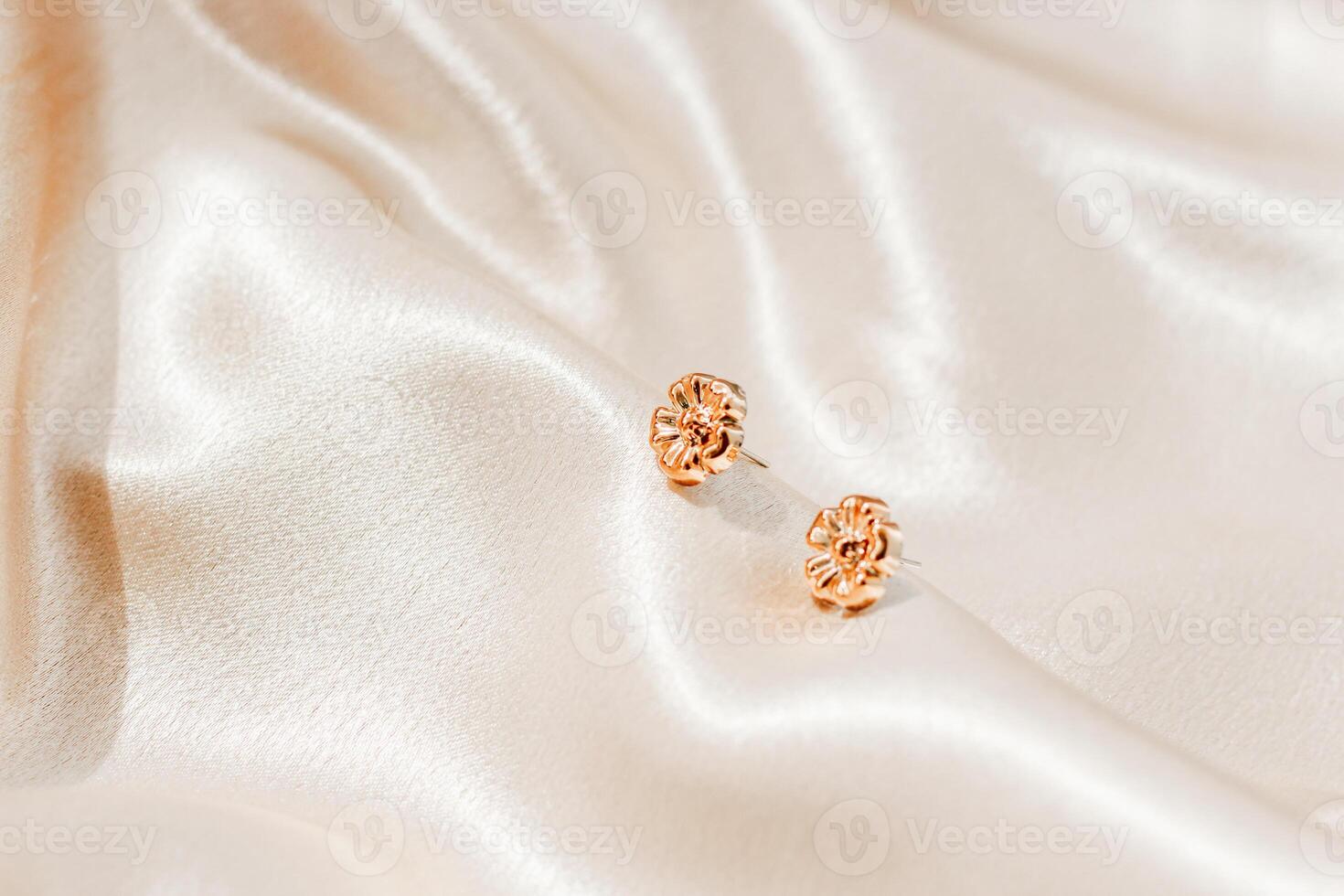 Elegant earrings displayed on soft fabric create a stunning visual for jewelry enthusiasts photo