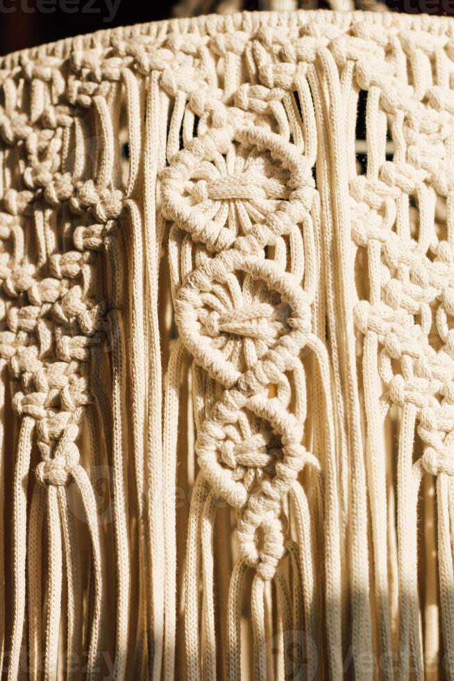 Intricate macrame textile design featuring unique knots and patterns crafted with natural fibers photo