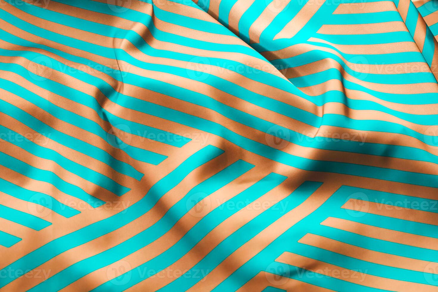 Colorful fabric with turquoise and peach stripes folded on a flat surface photo