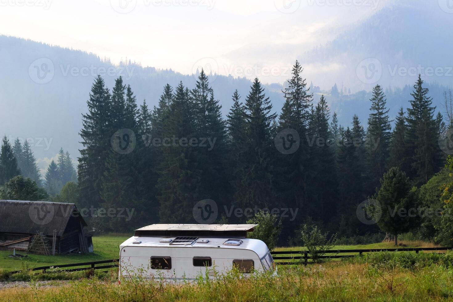 Serene camping adventure in a tranquil forest setting with a vintage caravan photo