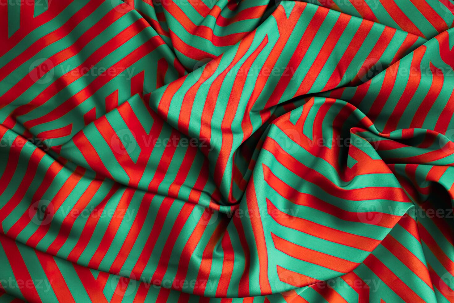 Vibrant green and orange striped fabric draped elegantly with intricate patterns photo