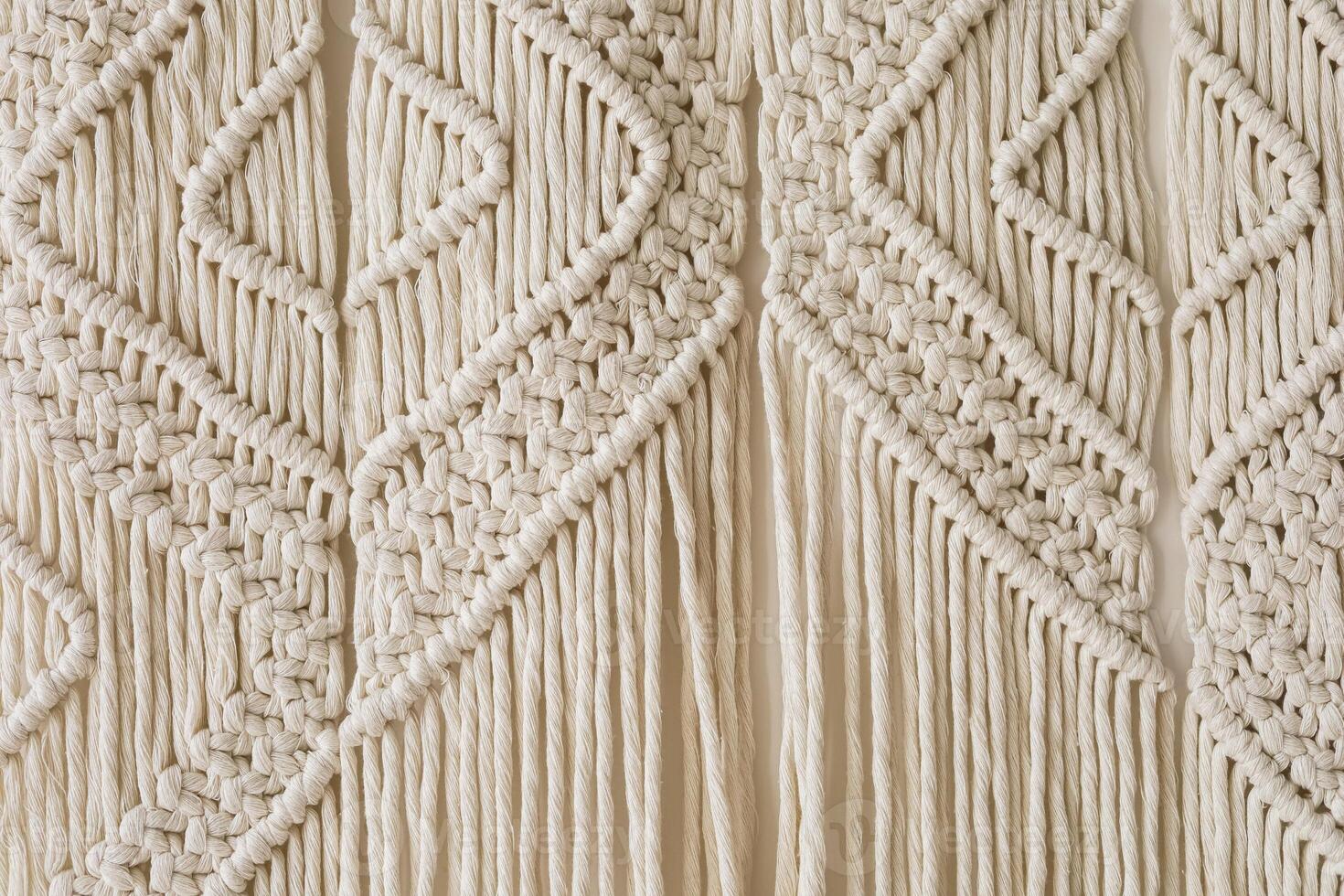 Macrame wall hanging featuring intricate patterns and textures crafted from natural fibers photo