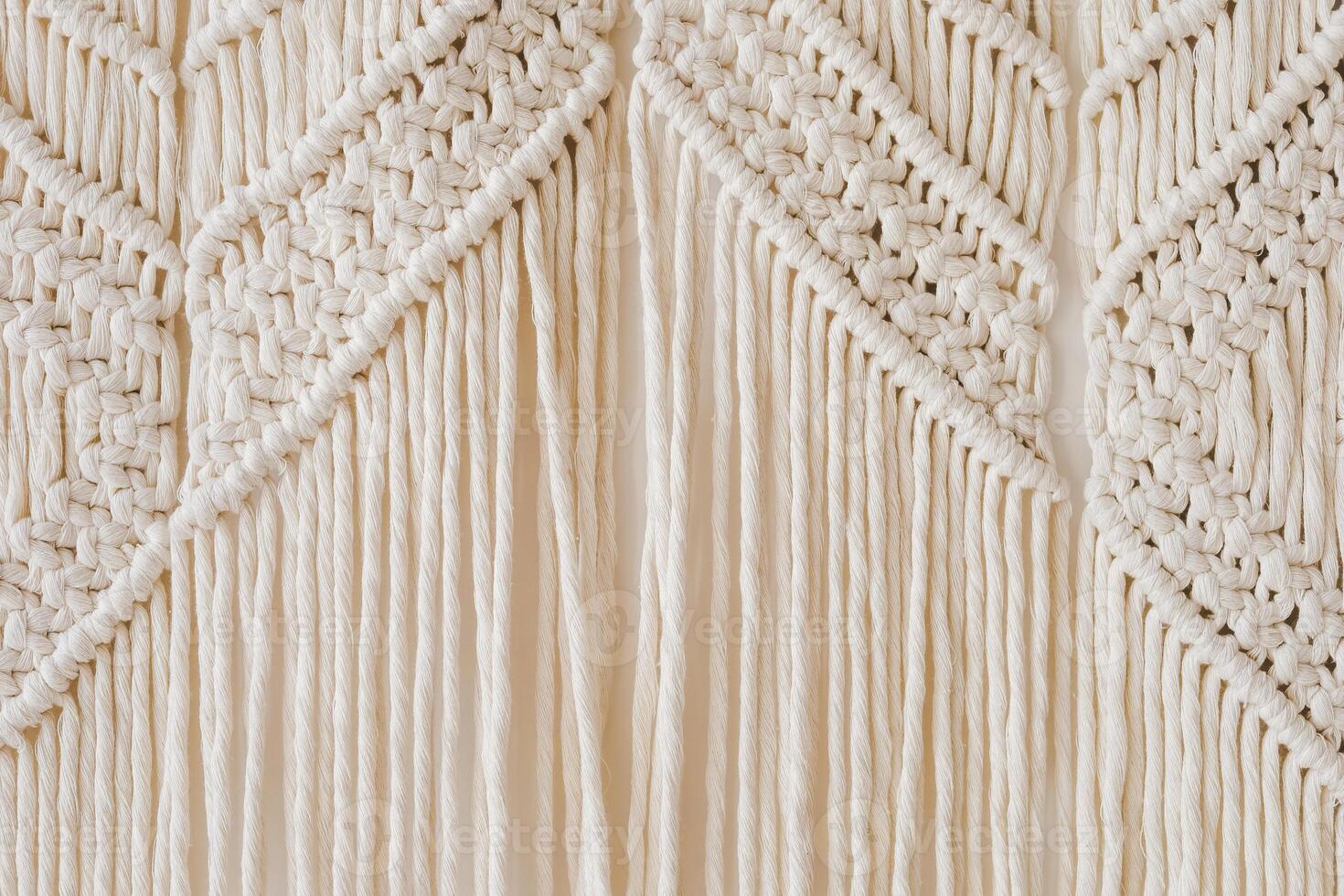 Beautiful macrame wall hanging showcasing intricate patterns and textures in neutral tones photo