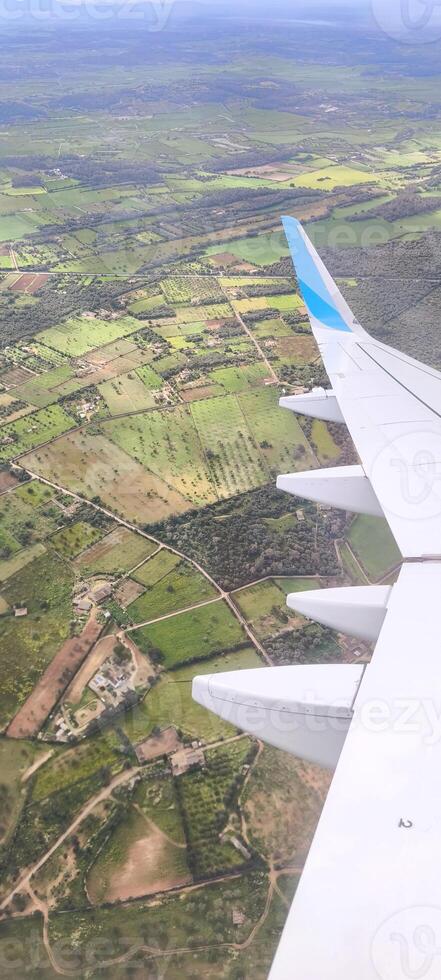 Landscape under the wing of an airplane during flight photo