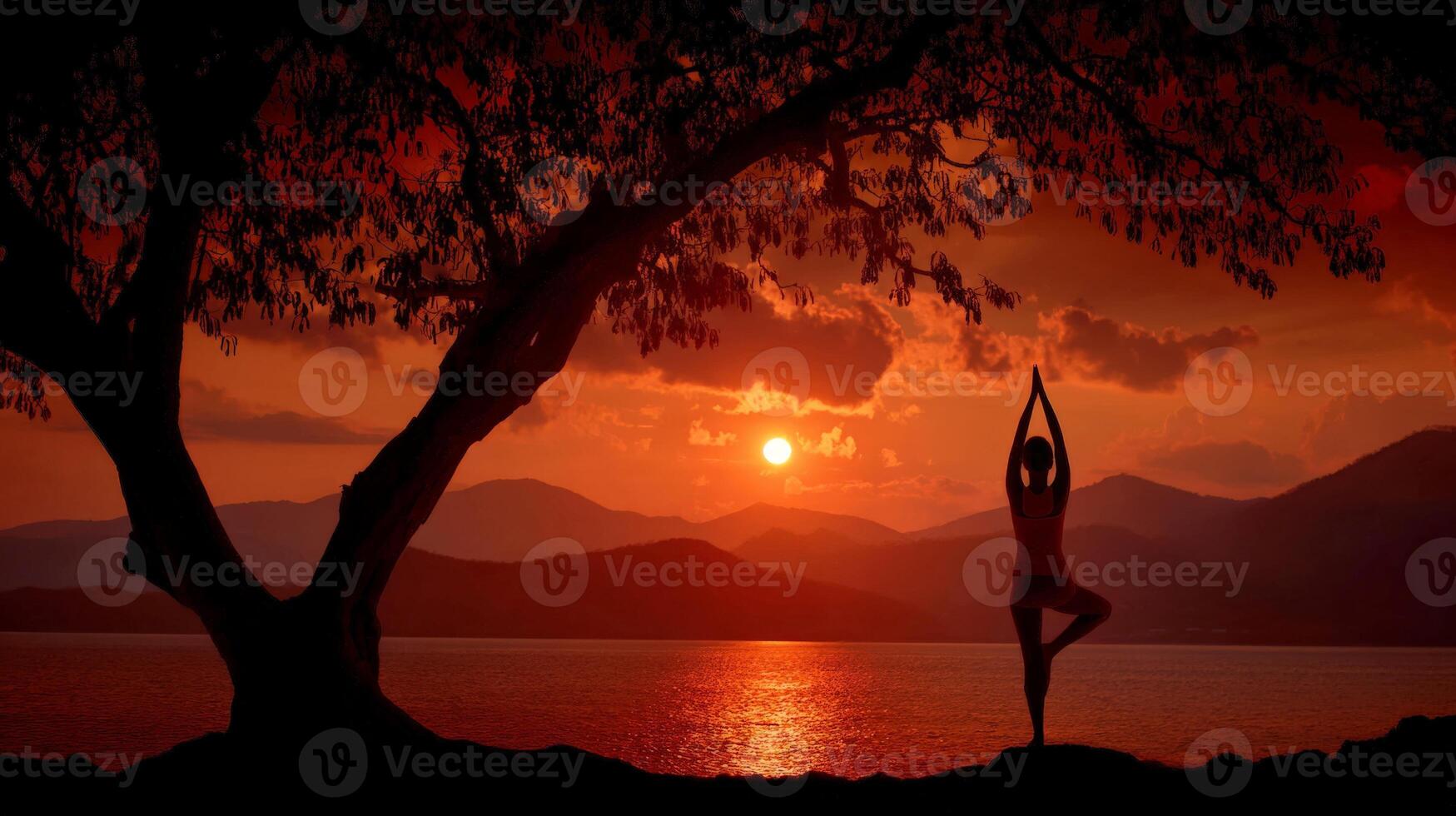 Silhouette of Woman in Tree Yoga Pose at Sunset, Mountains and Lake Background photo