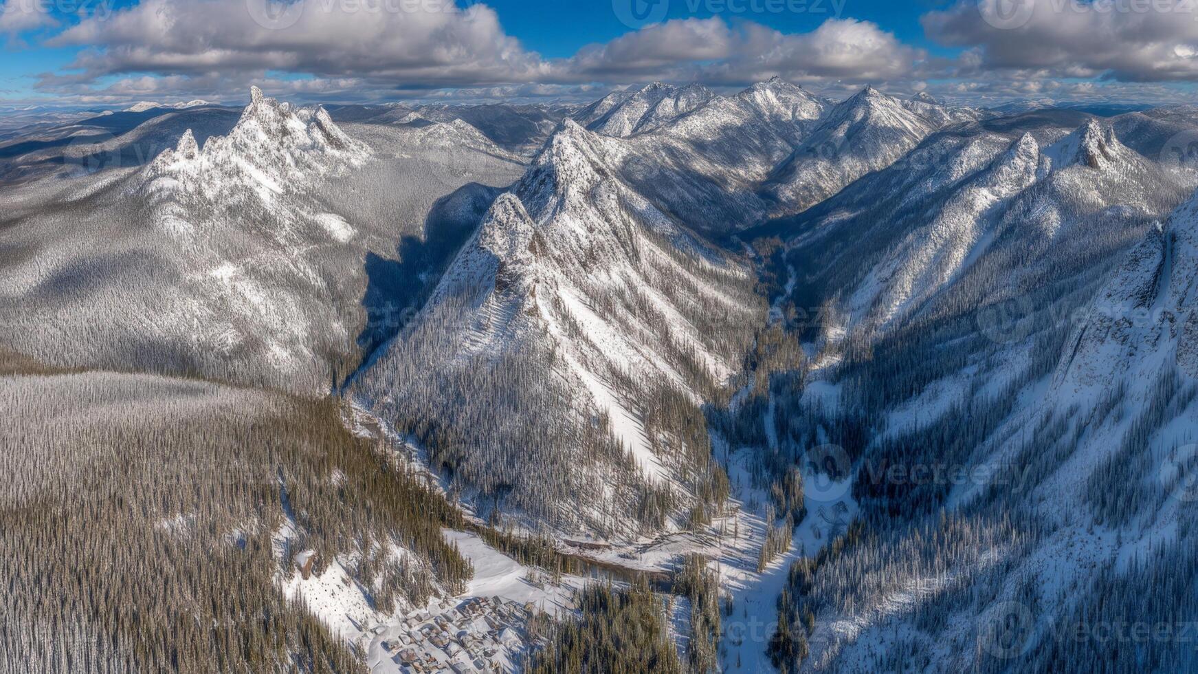 Panoramic Aerial View of Snowy Mountain Range in Winter photo