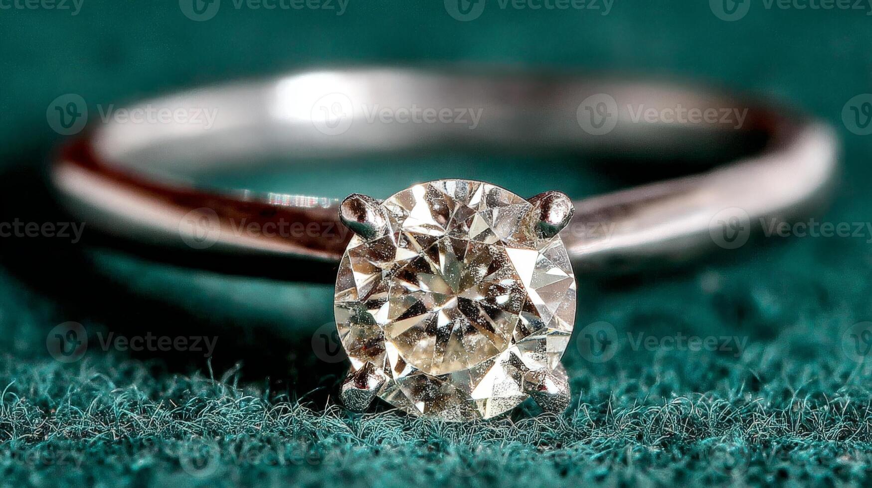 Closeup of Sparkling Solitaire Diamond Ring on Teal Fabric photo