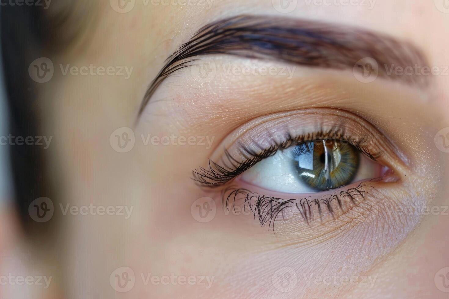 Woman showing perfect eyebrows and long eyelashes after beauty treatment photo