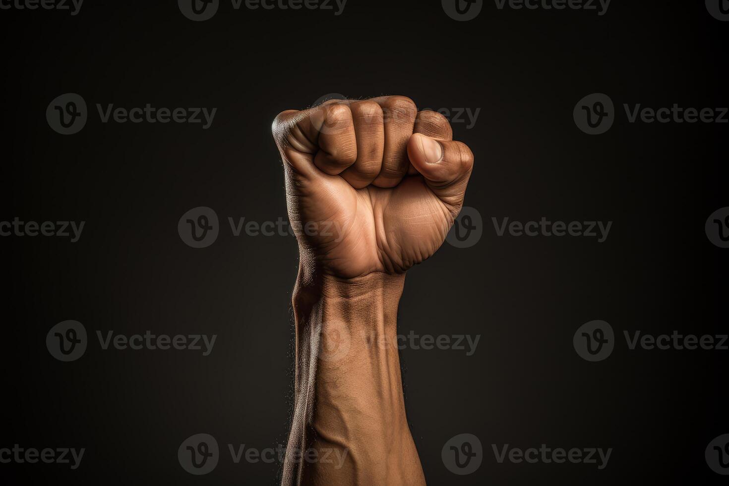 Clenched fist raised in protest symbolizing strength and resistance on dark background photo
