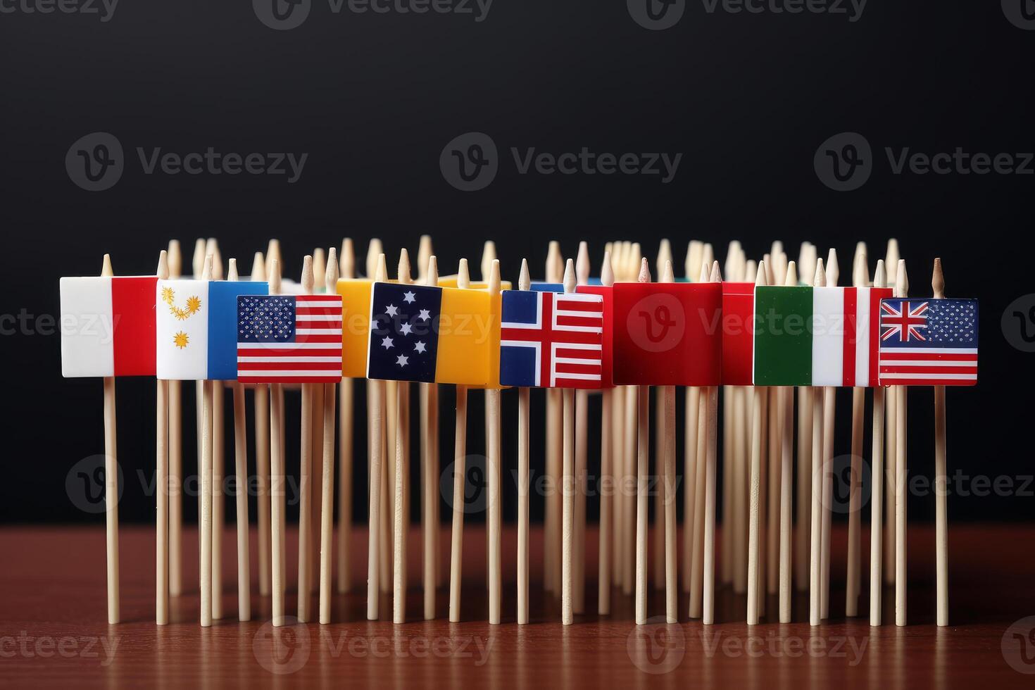 Small flags of different countries standing on toothpicks on black background photo