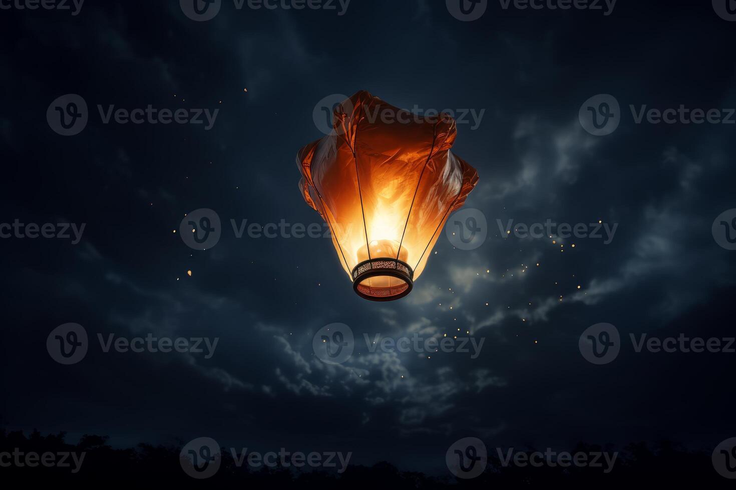 Sky lantern floating in night sky with other lanterns in background photo