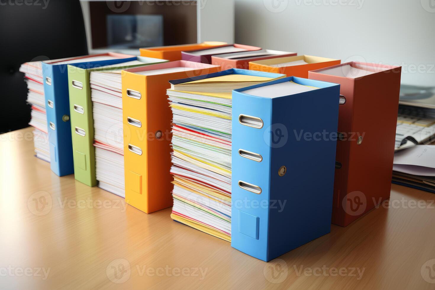 Colorful ring binders standing on desk are showing documents inside photo