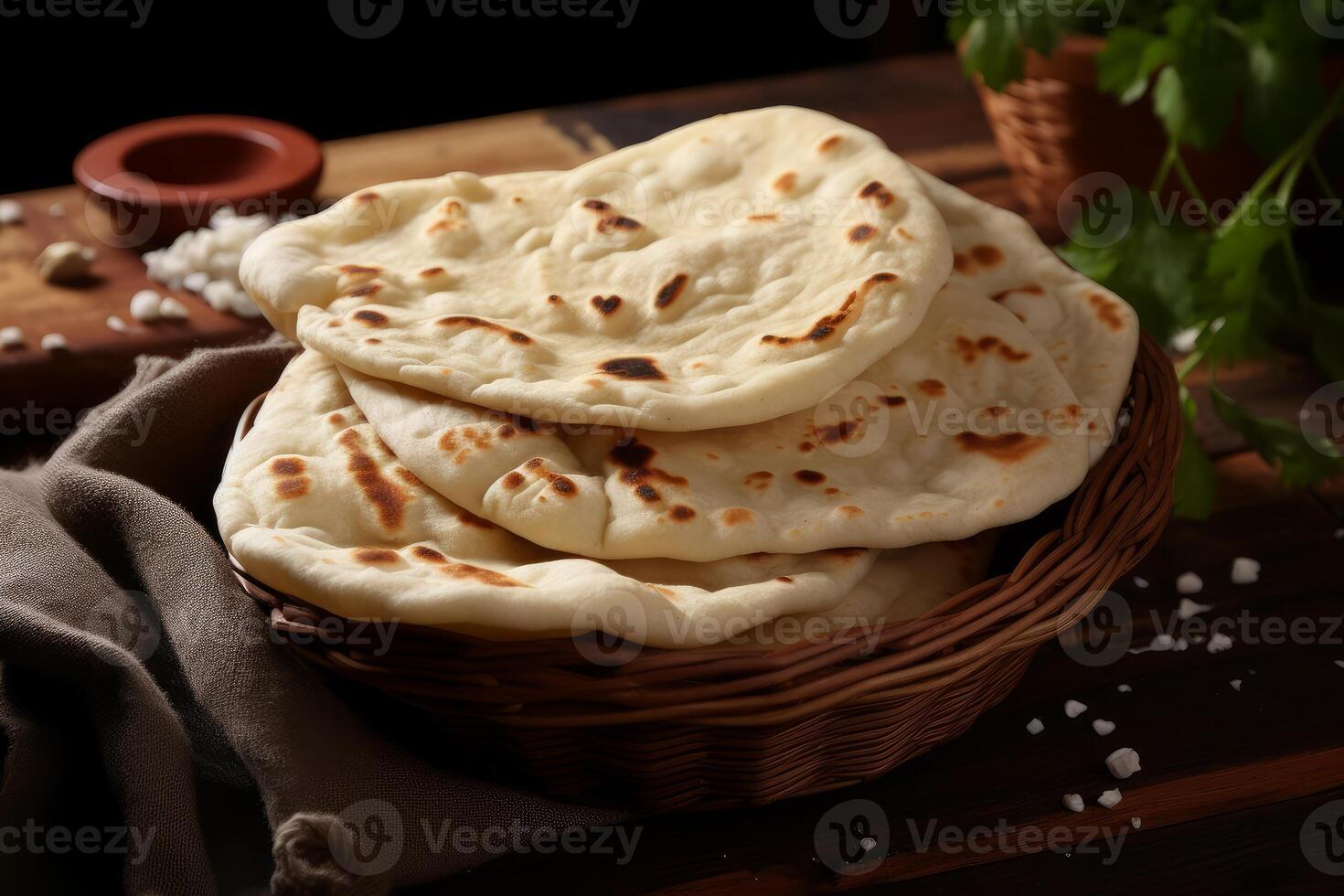 Pita bread showing air bubbles in a basket on rustic wood table photo