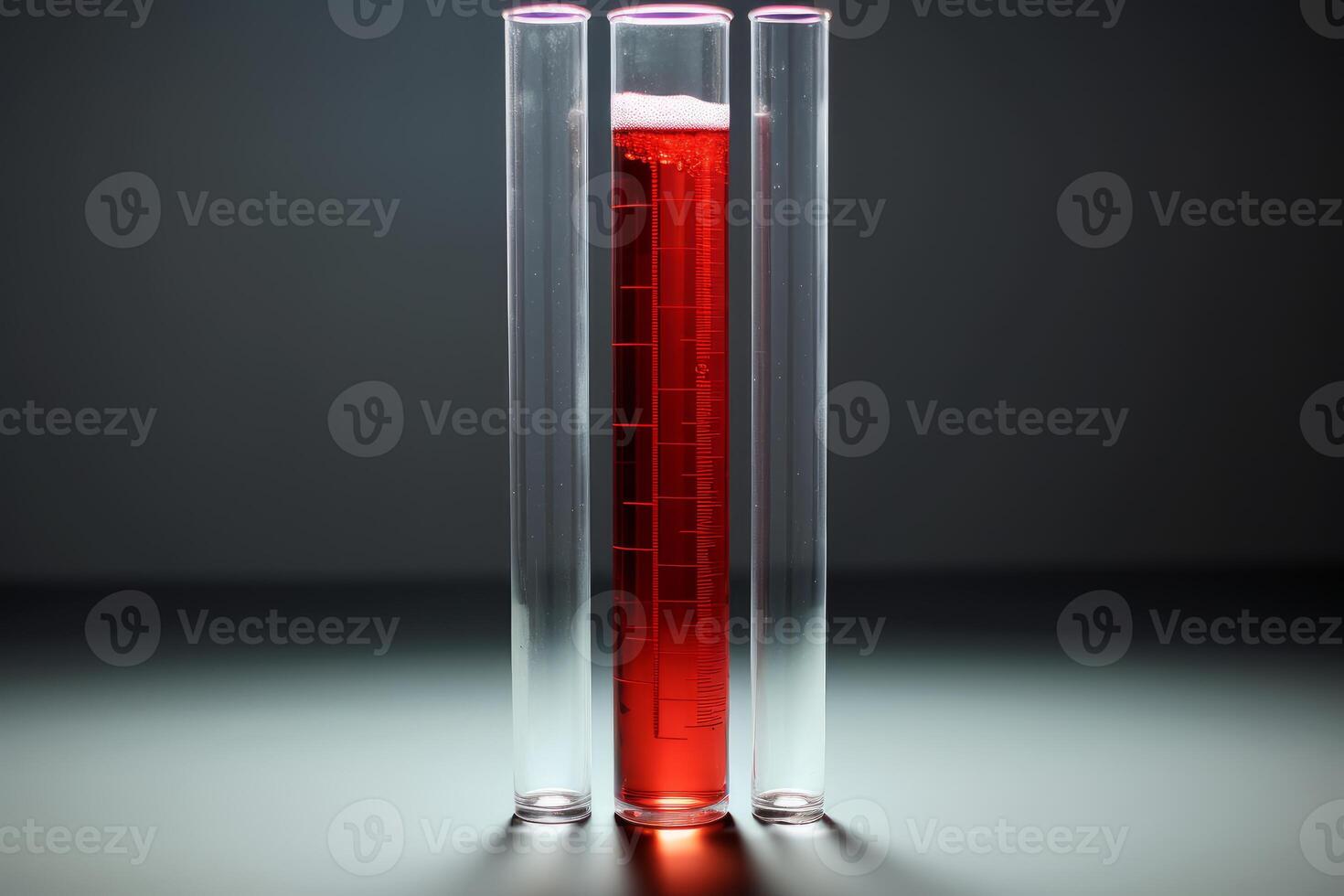 Graduated cylinder containing red chemical liquid stands between empty test tubes photo
