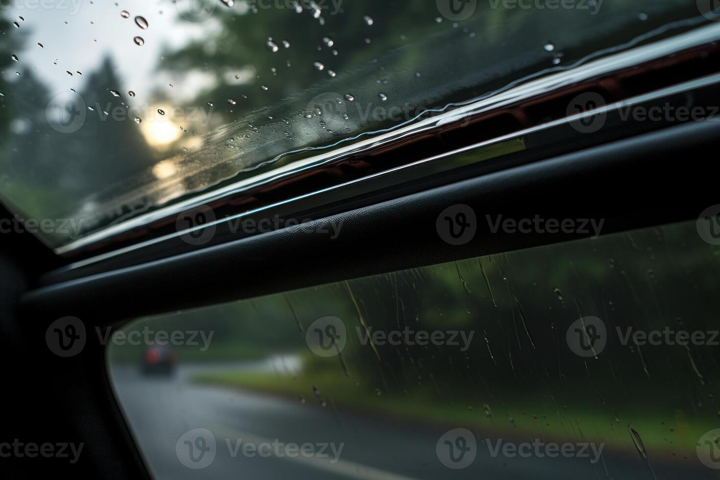 Raindrops sliding on car window during a road trip photo