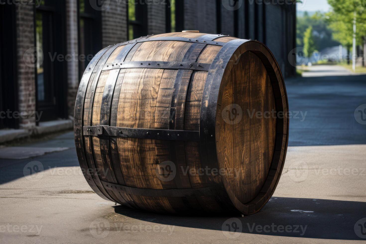 Oak barrel lying on the ground near distillery in sunny day photo