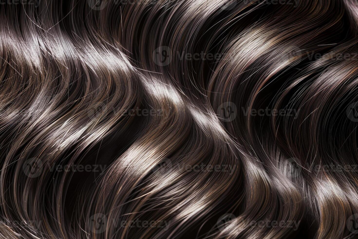 Closeup of shiny wavy healthy black hair texture forming an elegant pattern photo