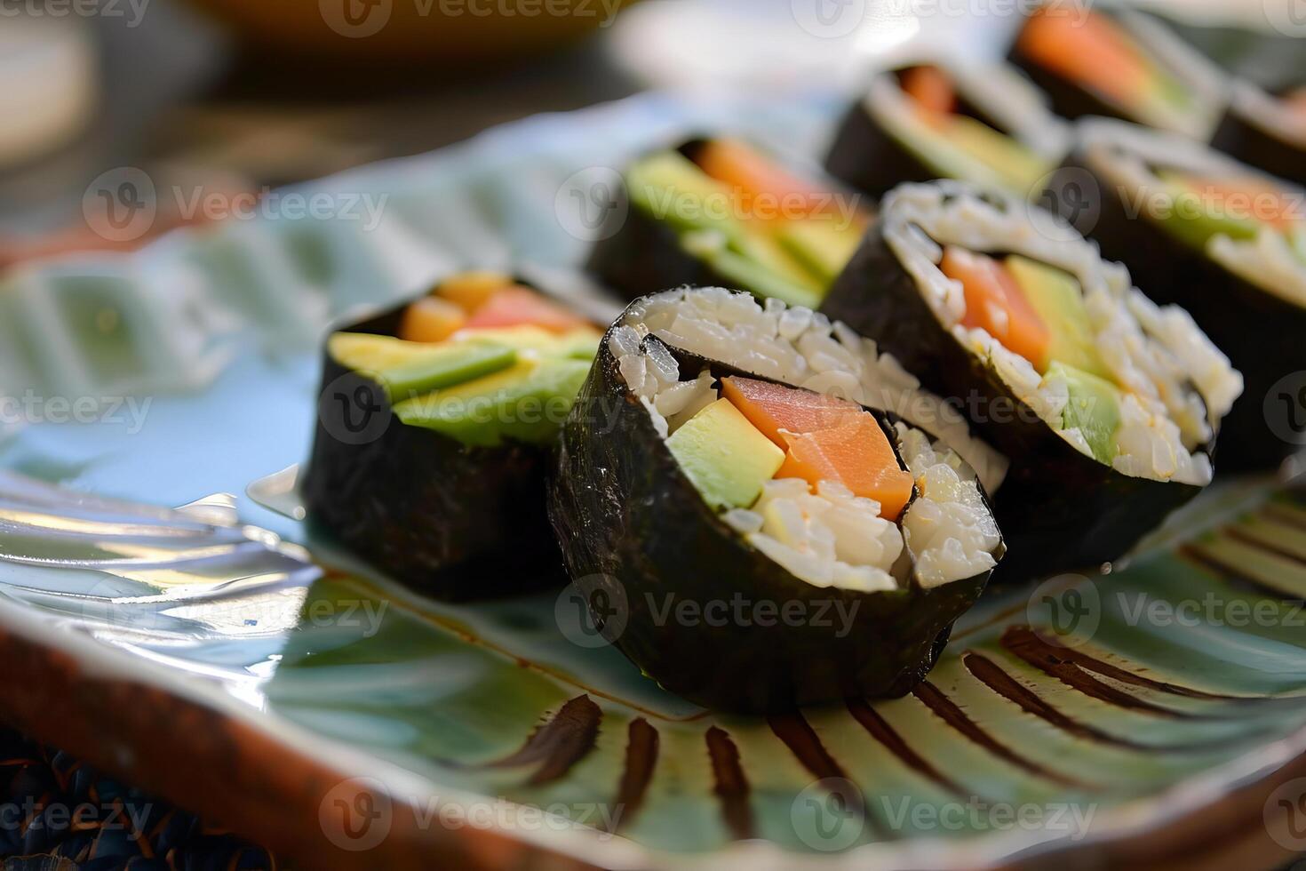 Delicious sushi rolls with salmon and avocado filling resting on a plate photo