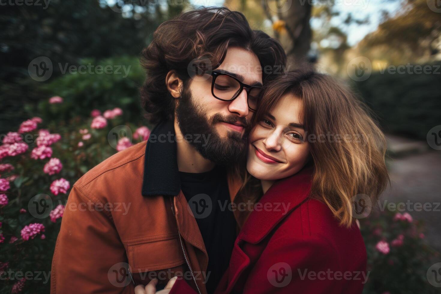 Young couple embracing in a park during autumn, showing love and affection photo