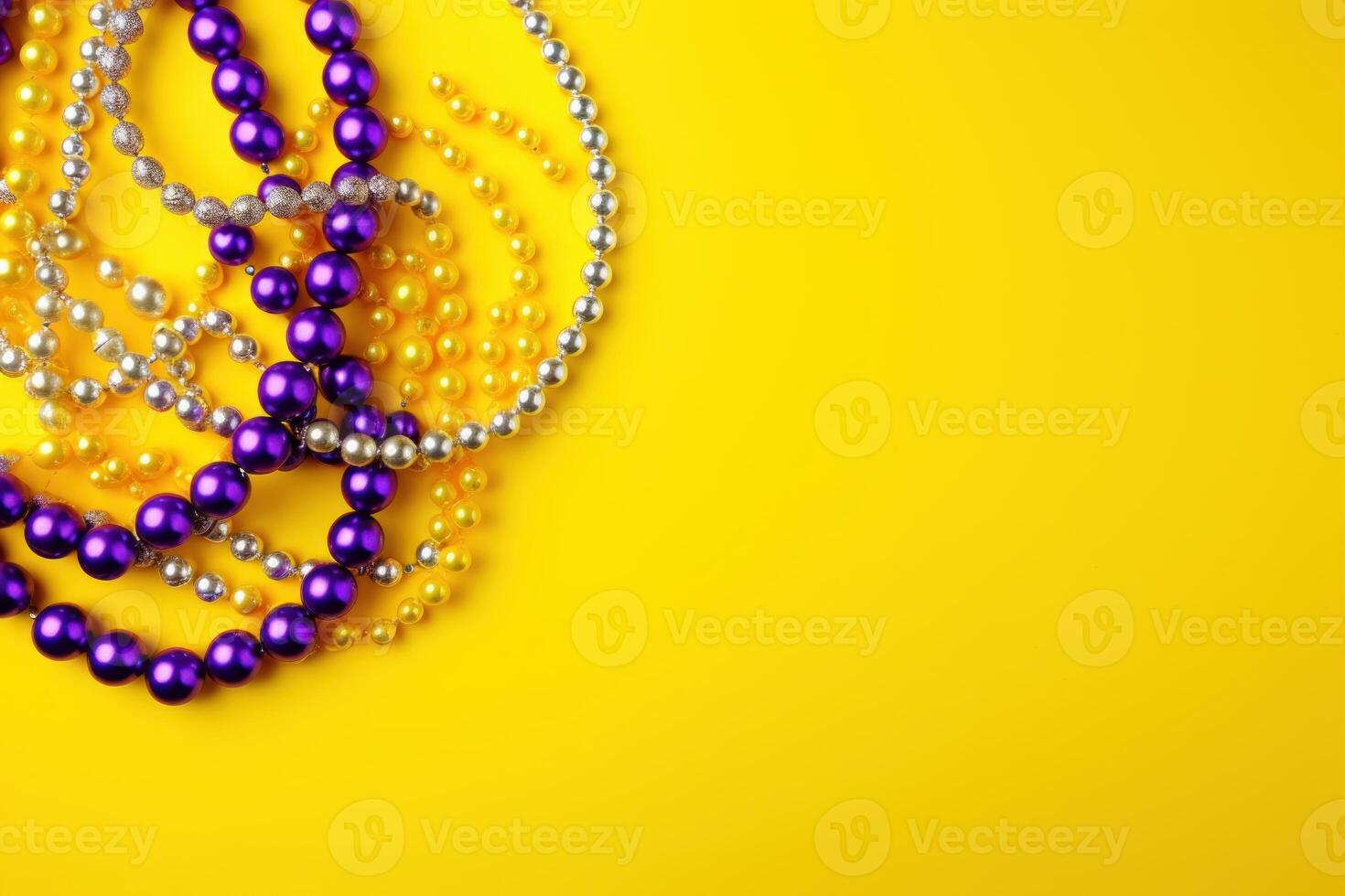 Mardi gras beads on yellow background creating festive atmosphere for celebration photo